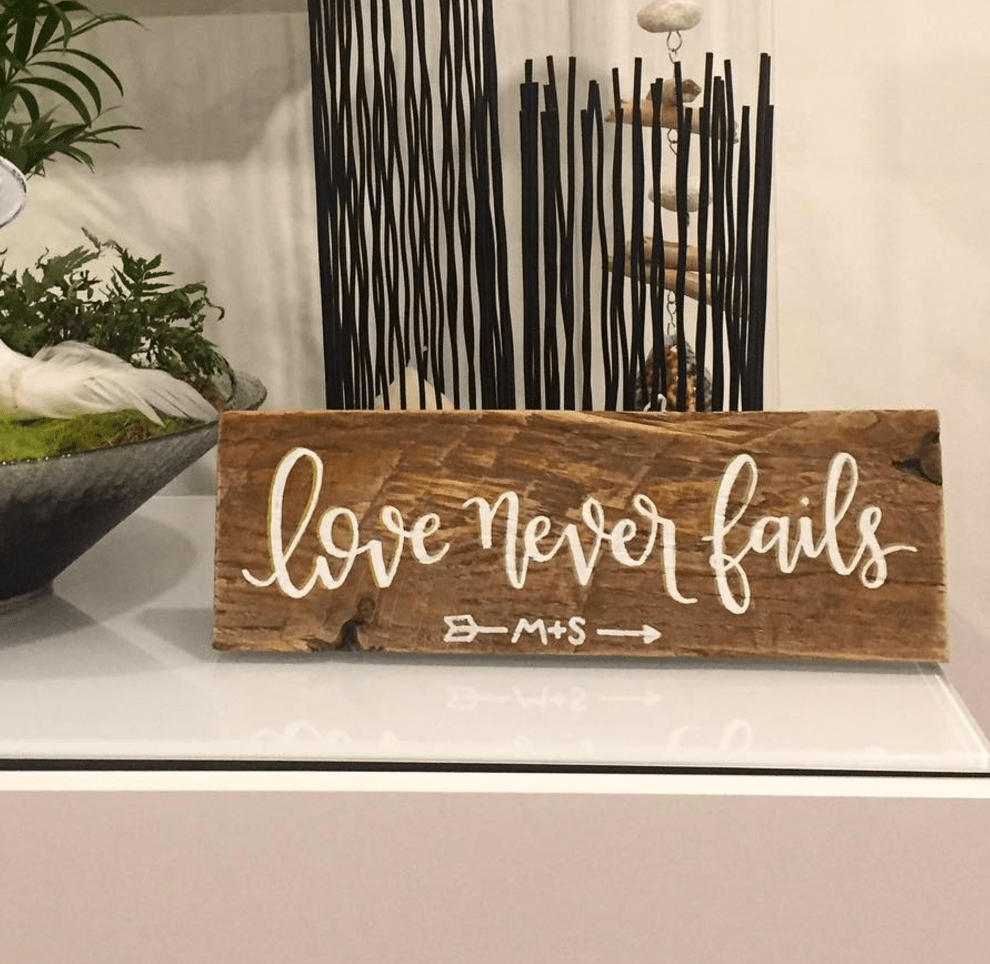 Love Never Fails Wood Sign